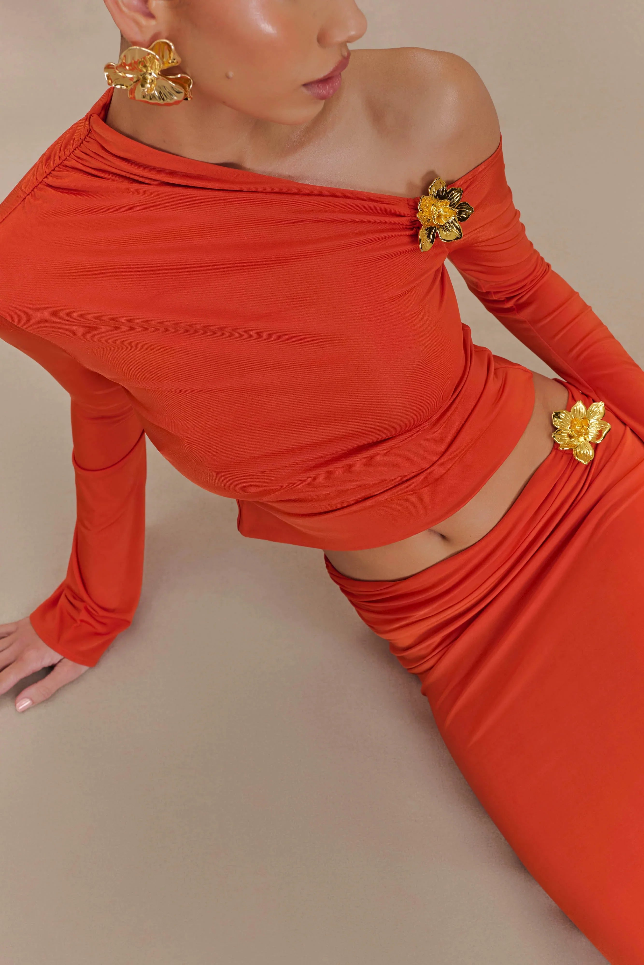 Ainsley Asymmetrical Long Sleeve Top With Floral Hardware Burnt Orange