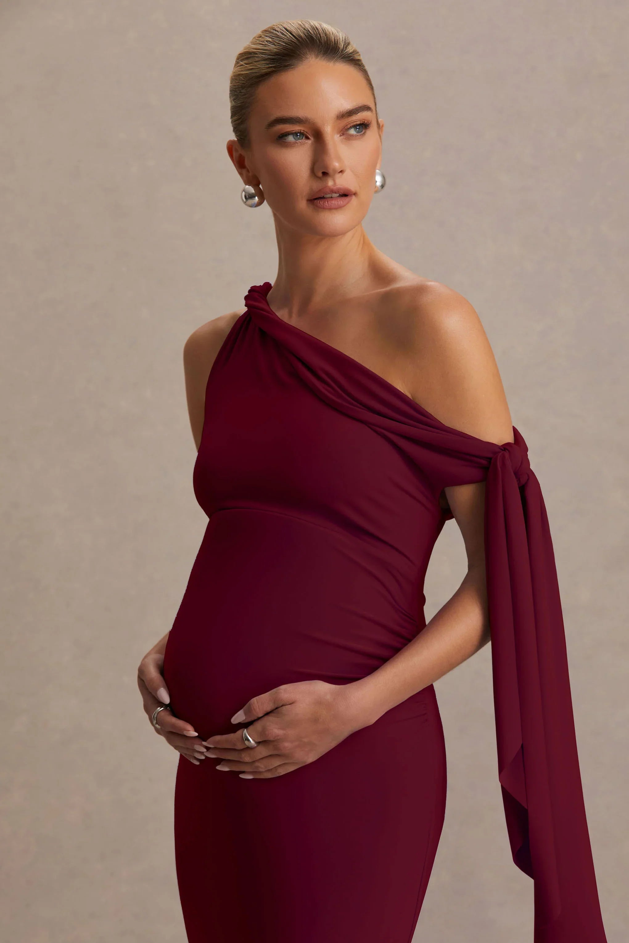 Orielle Burgundy Asymmetric Neck Maternity Maxi Dress With Knot Sleeve And Sash